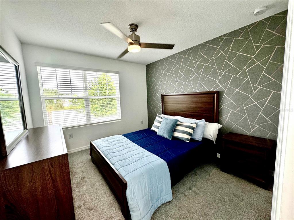 10251 Highline Crest Street Orlando, FL 32832 - Photo 25 of 35 a bedroom with a bed and a window