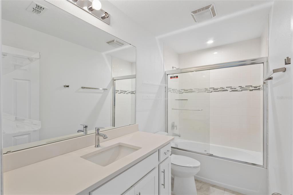 10251 Highline Crest Street Orlando, FL 32832 - Photo 26 of 35 a bathroom with a sink a toilet and shower