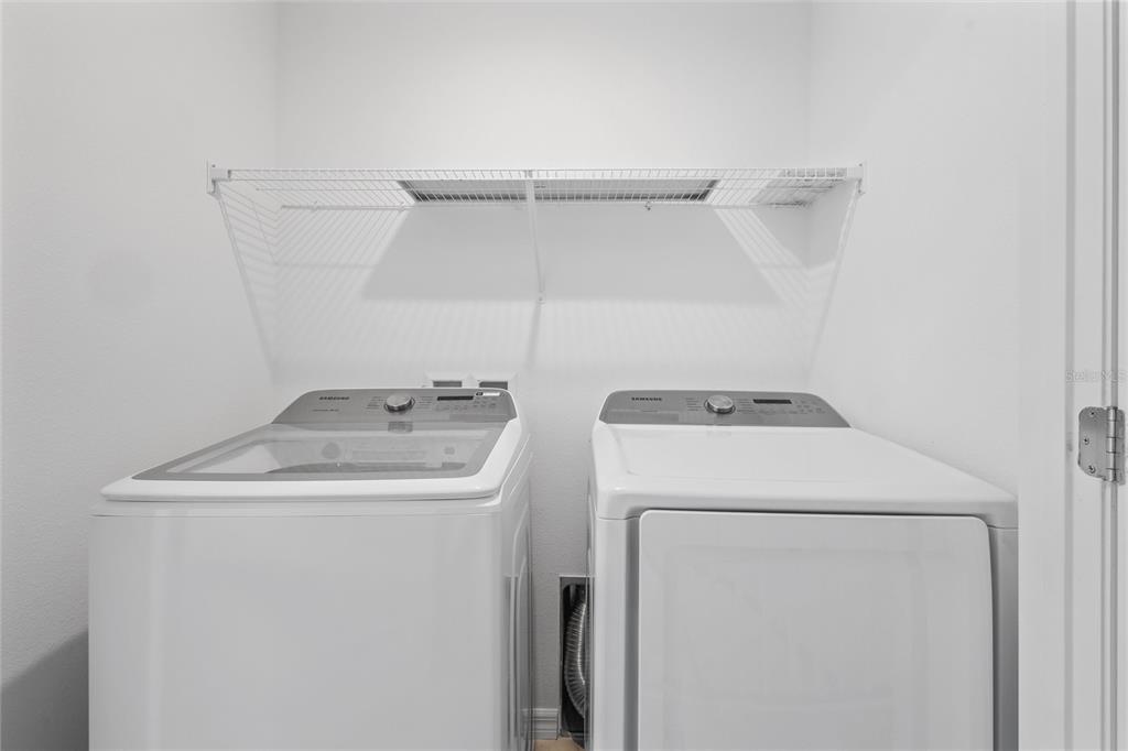 10251 Highline Crest Street Orlando, FL 32832 - Photo 30 of 35 a utility room with dryer and washer