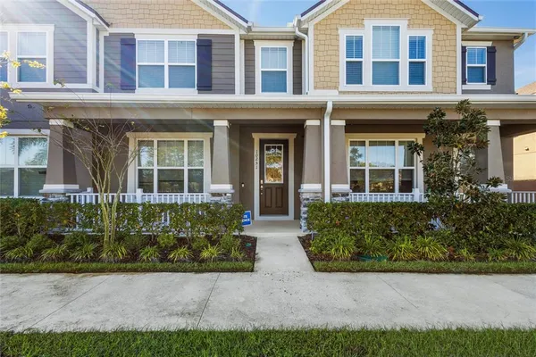 front view of a brick house with a yard
