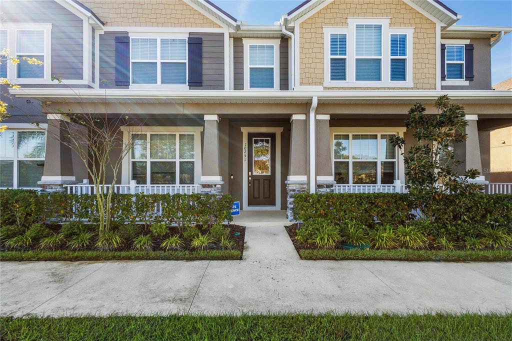10251 Highline Crest Street Orlando, FL 32832 - Photo 4 of 35 front view of a brick house with a yard