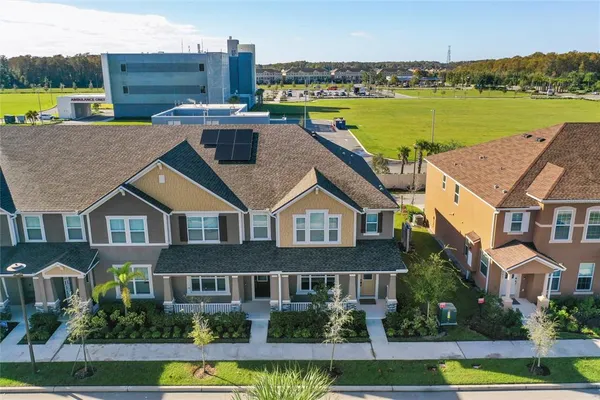 a aerial view of a house with a garden and a lake view