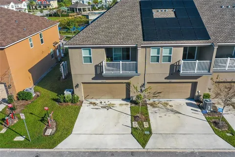 an aerial view of a house with a swimming pool yard and outdoor seating