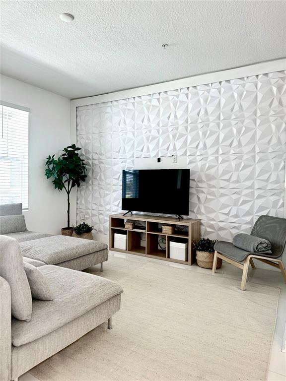 10251 Highline Crest Street Orlando, FL 32832 - Photo 10 of 35 a living room with furniture and a flat screen tv