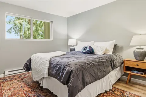 a bedroom with a bed and wooden floor