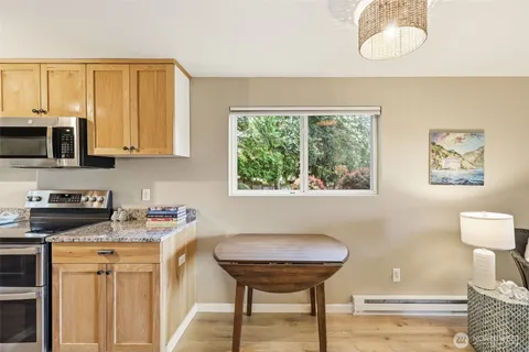 a kitchen with stainless steel appliances granite countertop a stove a sink and a microwave
