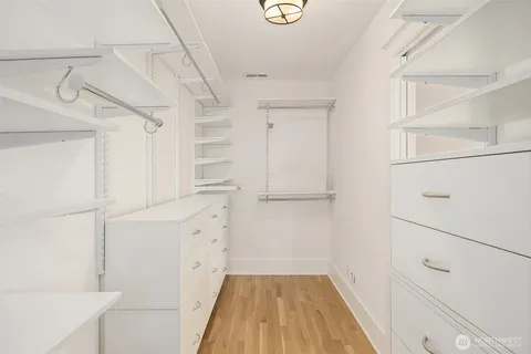 a view of walk in closet with empty racks