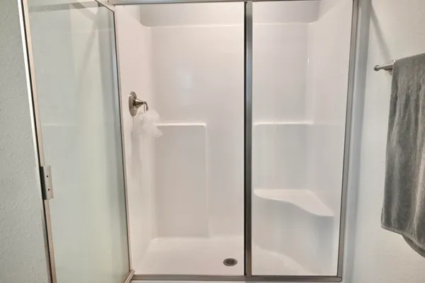 a bathroom with a glass shower door