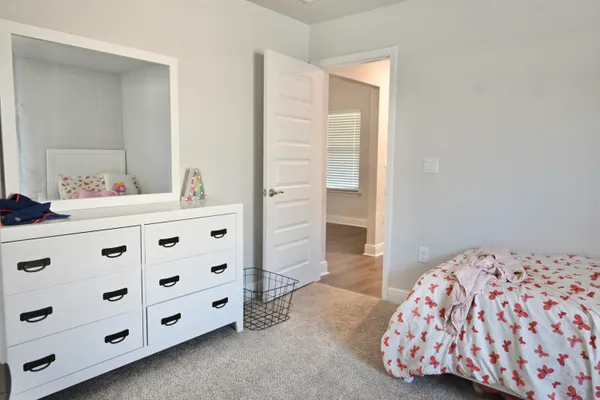 a bedroom with a dresser and a dresser