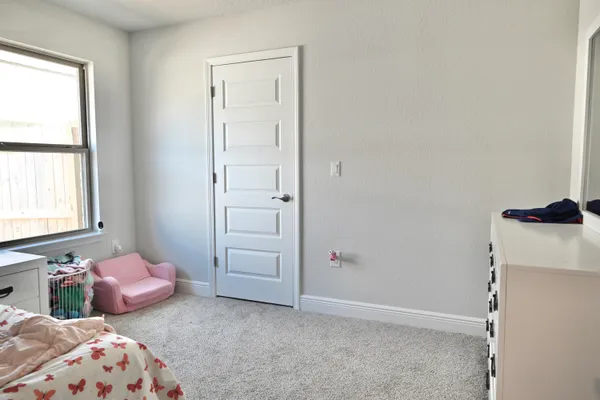 a bedroom with bed and a window