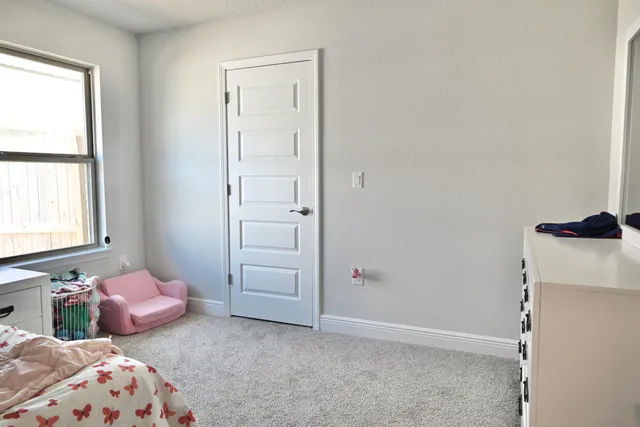 a bedroom with a bed and window