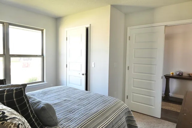 a bedroom with a bed and a window