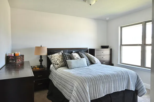 a bedroom with a bed and window