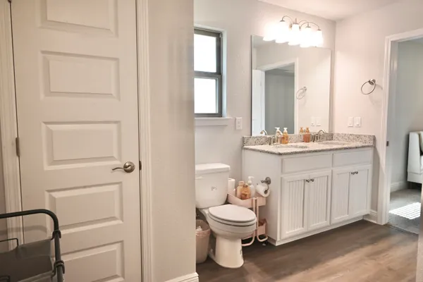 a bathroom with a toilet sink and mirror