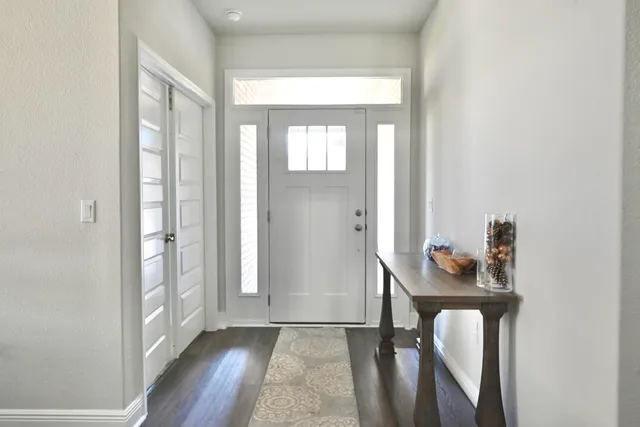 a dining room with furniture a chandelier and wooden floor