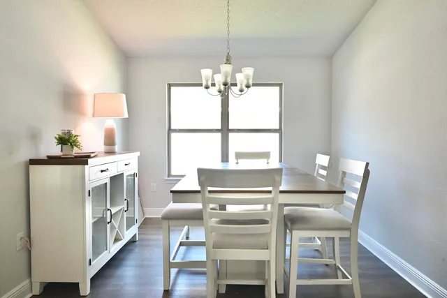 a kitchen with stainless steel appliances granite countertop a sink a stove and chairs