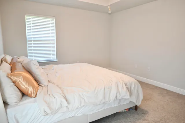 a bathroom with a granite countertop sink toilet and mirror