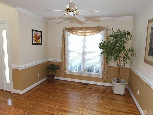 2212 Laurel Valley Way Raleigh, NC 27604 - Photo 4 of 25 Formal Dining Room features gleaming hardwood floors, chair rail and crown molding!