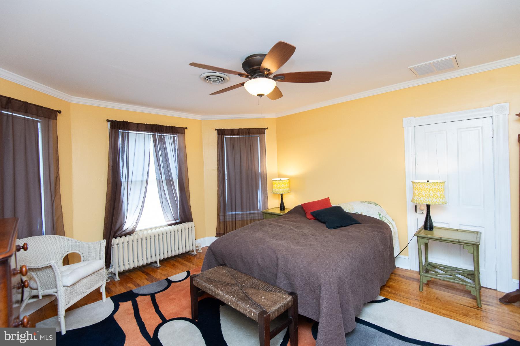 606 Locust Street Cambridge, MD 21613 - Photo 22 of 37 a bedroom with a bed and a chandelier