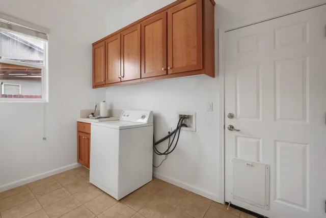 a spacious bathroom with a tub sink and mirror