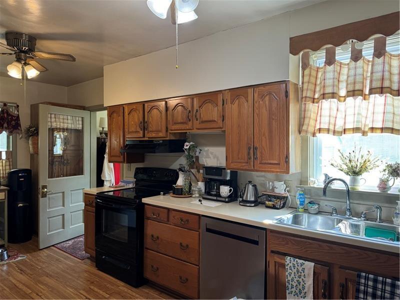 149 South Franklin Street Prospect, PA 16052 - Photo 5 of 25 a kitchen with granite countertop a stove a sink and dishwasher wooden cabinets with wooden floor