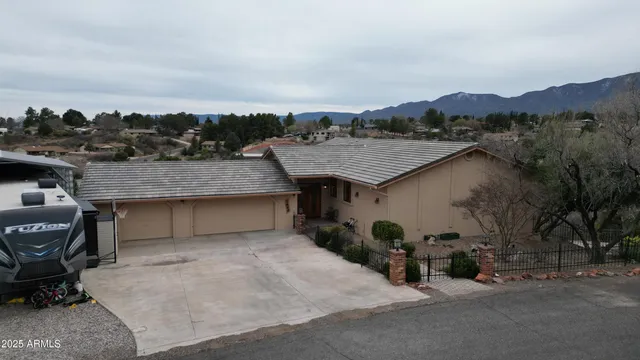 an aerial view of a house roof deck with a table and chairs