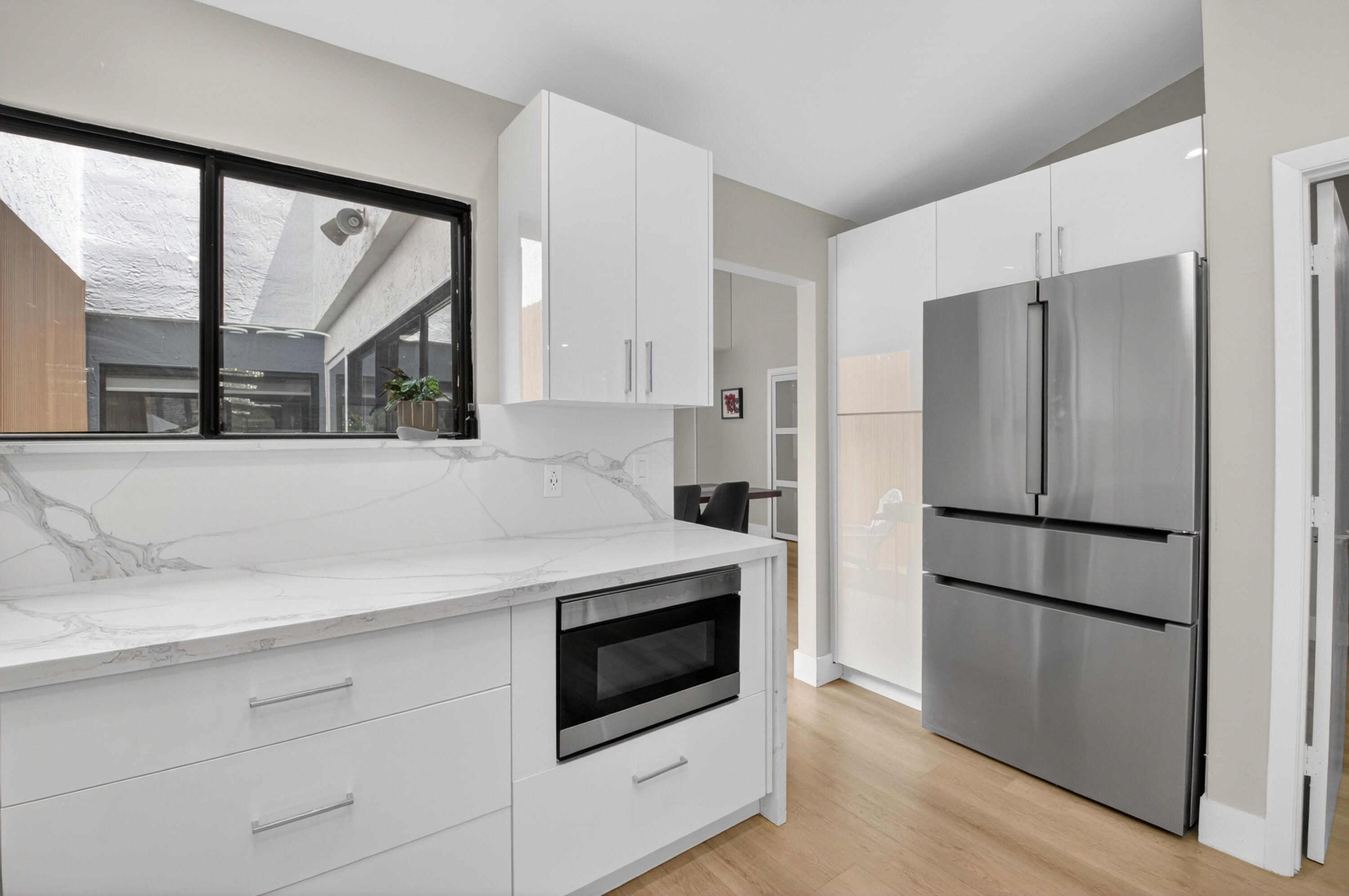 7374 Woodmont Court Boca Raton, FL 33434 - Photo 8 of 95 a kitchen with a refrigerator and a stove