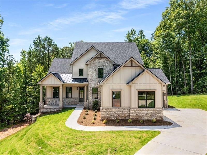 7262 Creekside Way Jefferson, GA 30549 - Photo 1 of 1 a front view of a house with a yard garage and outdoor seating