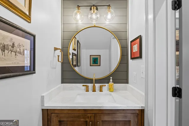 a bathroom with a granite countertop sink a toilet and shower