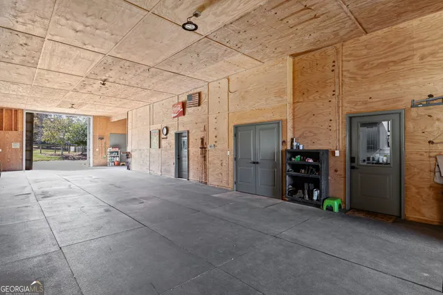 an aerial view of a house with a yard and lake view in back