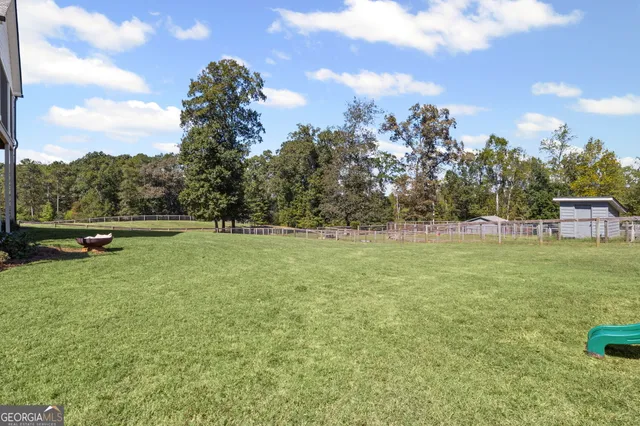 an aerial view of a house with a yard and lake view