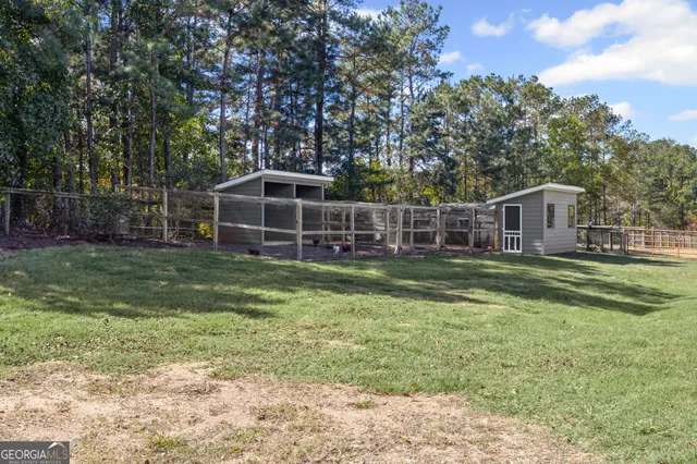 an aerial view of a house with a yard and large trees
