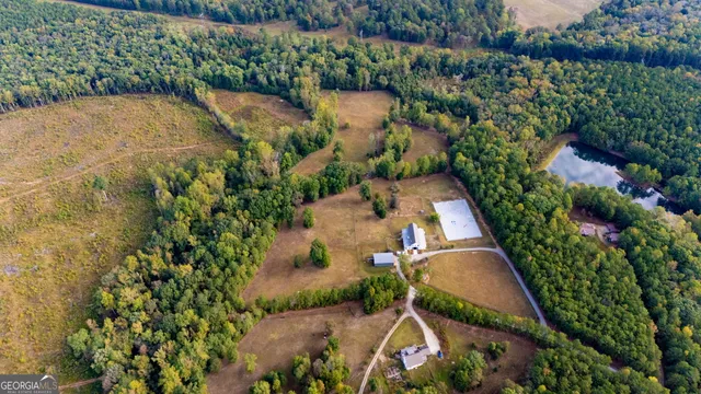an aerial view of a house with swimming pool and patio