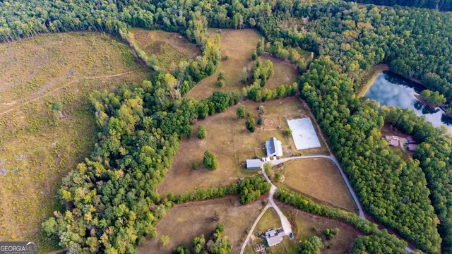 an aerial view of a house with a yard and lake view