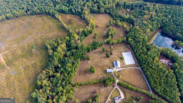 an aerial view of a house with a yard and garden