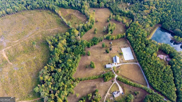 an aerial view of a house with outdoor space and a lake view