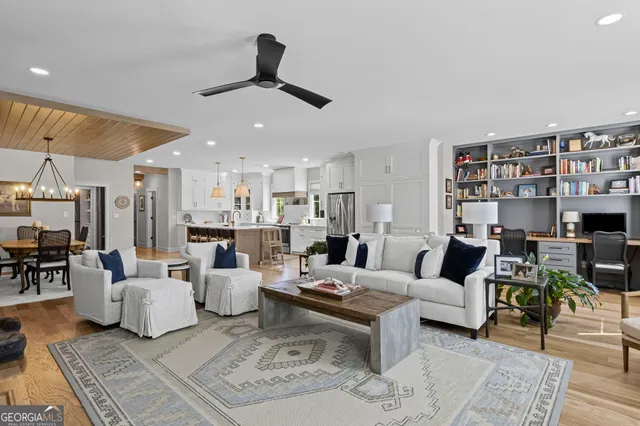a kitchen with stainless steel appliances white cabinets and a window