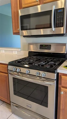 a stove top oven sitting inside of a kitchen