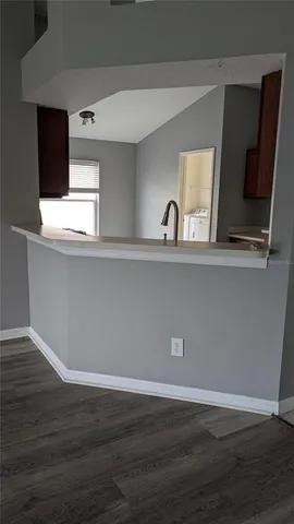 a view of living room with wooden floor and flat screen tv