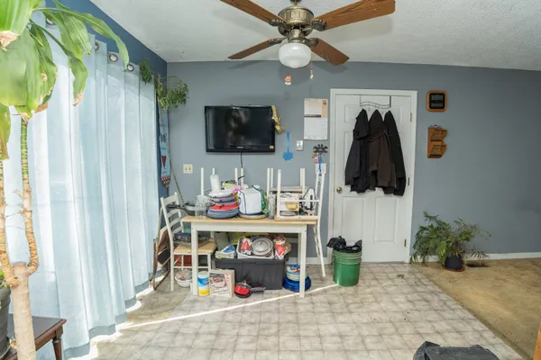 a room with a flat screen tv and a fireplace