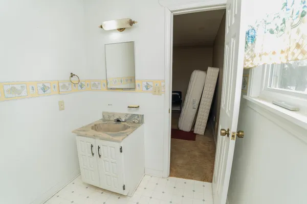 a bathroom with a sink a mirror and shower