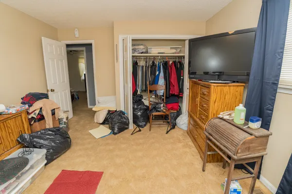 a bedroom with furniture and a flat screen tv