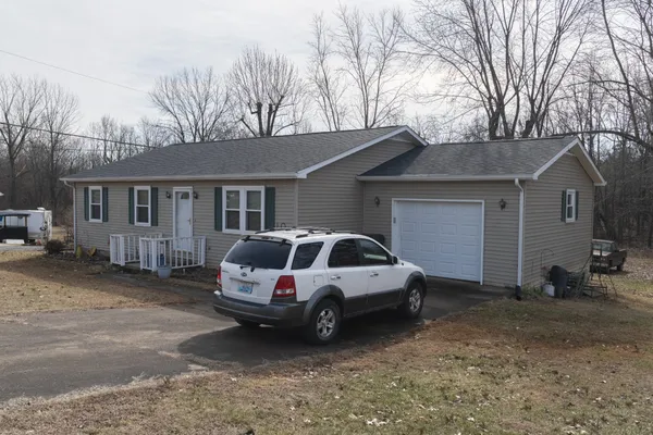 a car parked in front of white house