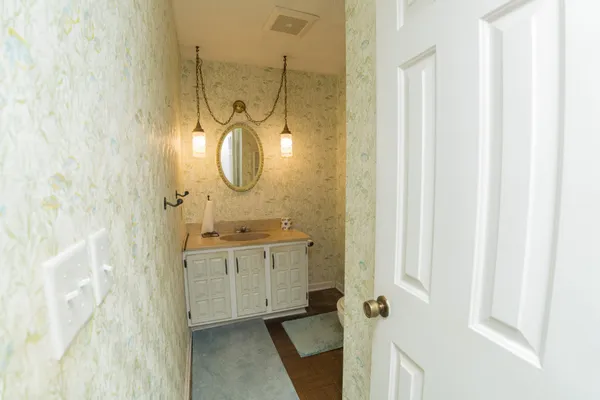 a bathroom with a granite countertop sink a mirror and a shower