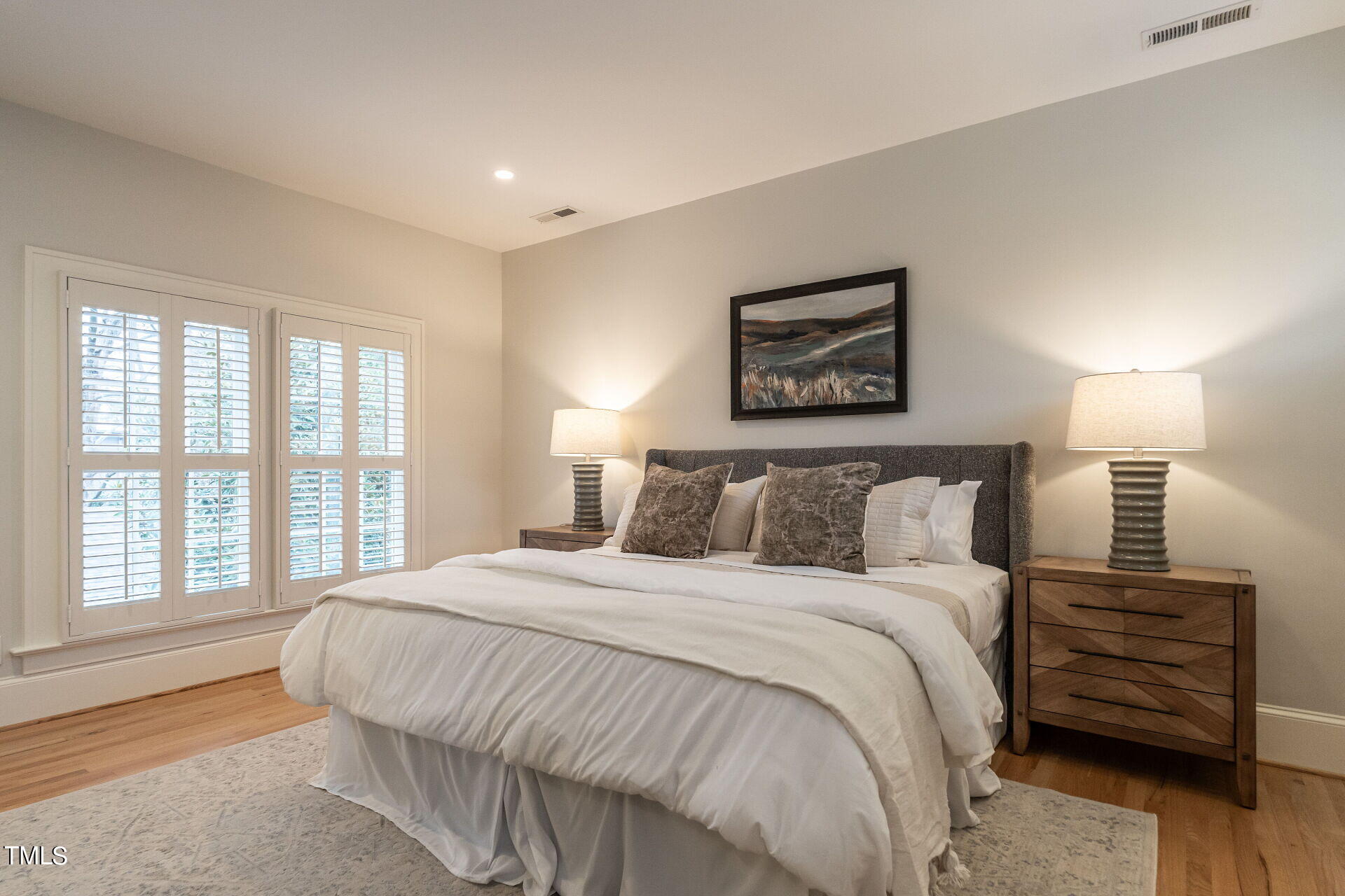 1610 St Marys Street Raleigh, NC 27608 - Photo 26 of 41 a bedroom with a bed a painting and a window