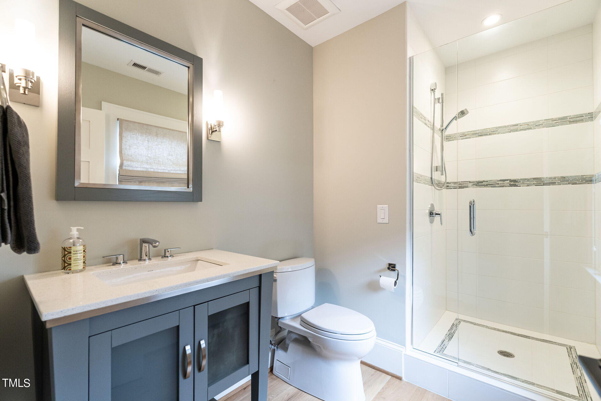 1610 St Marys Street Raleigh, NC 27608 - Photo 32 of 41 a bathroom with a sink a toilet and shower