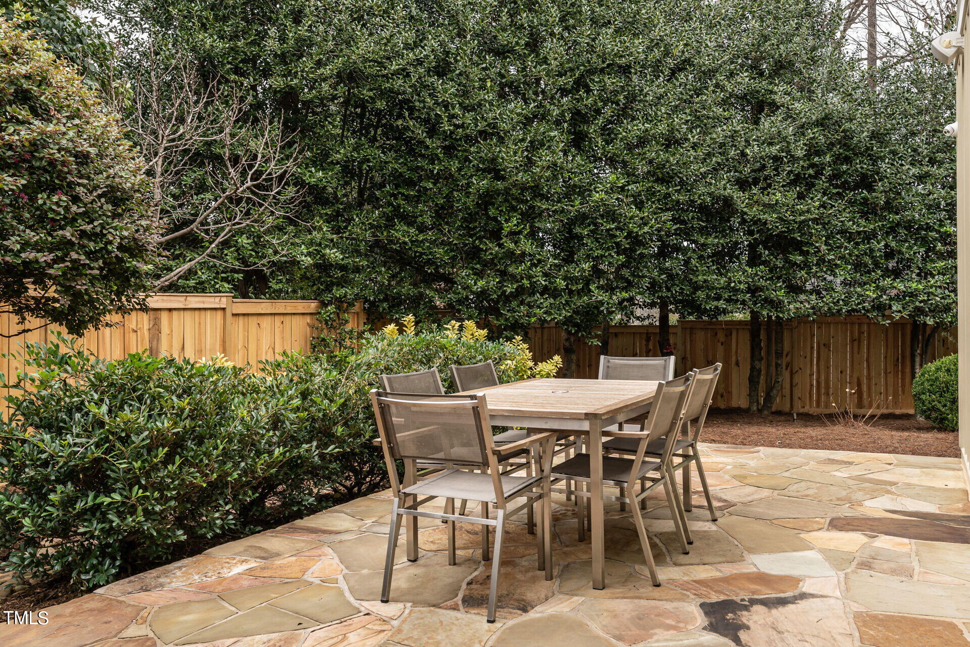 1610 St Marys Street Raleigh, NC 27608 - Photo 34 of 41 a patio with table and chairs and potted plants
