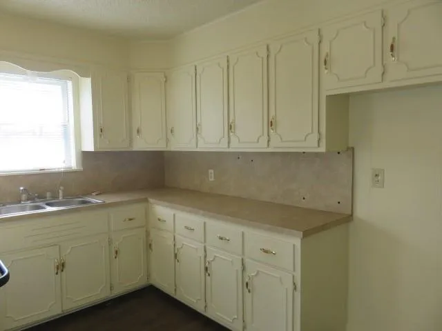 a kitchen with white cabinets