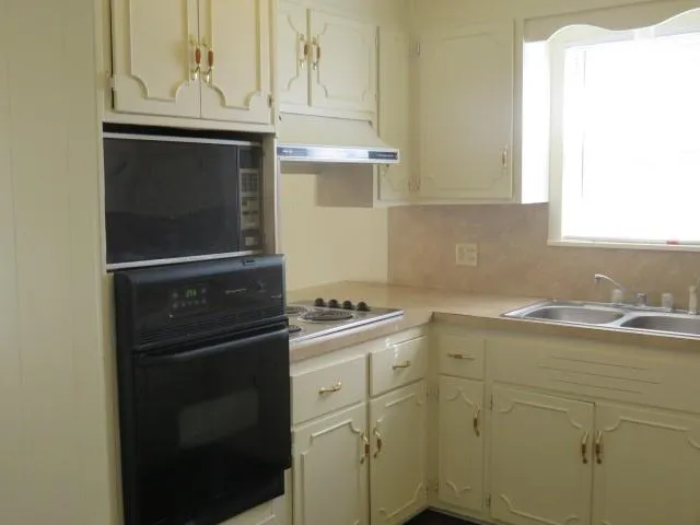 a kitchen with a stove and a sink