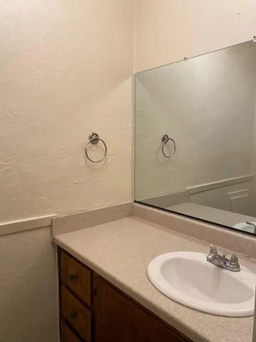 a bathroom with a sink and mirror